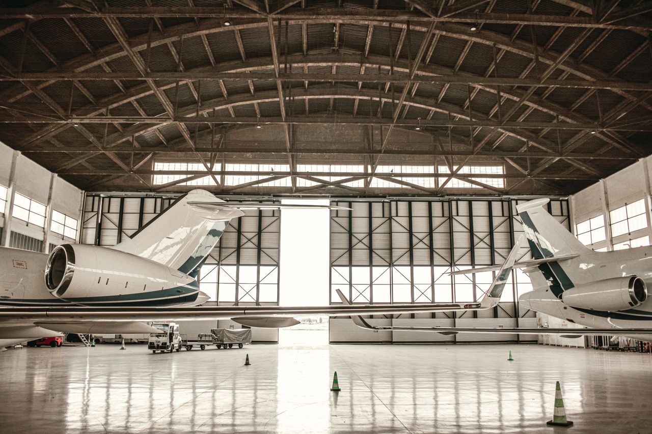 About Private jets parked inside a large hangar in Paris, offering a glimpse into aviation luxury.