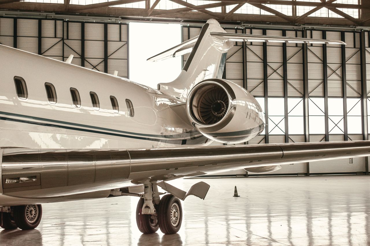 About A sleek private jet parked inside a modern hangar in Paris, France.